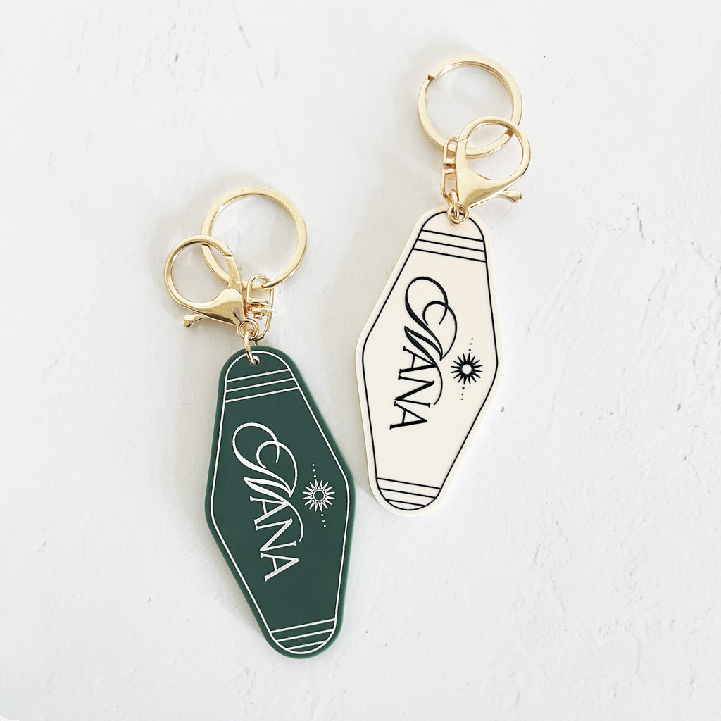 black or white custom motel keychain with gold lettering